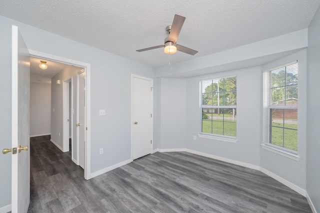 504 Shortwell Ave, Crestview, FL 32539 - unfurnished bedroom with dark wood finished floors, a textured ceiling, and a ceiling fan