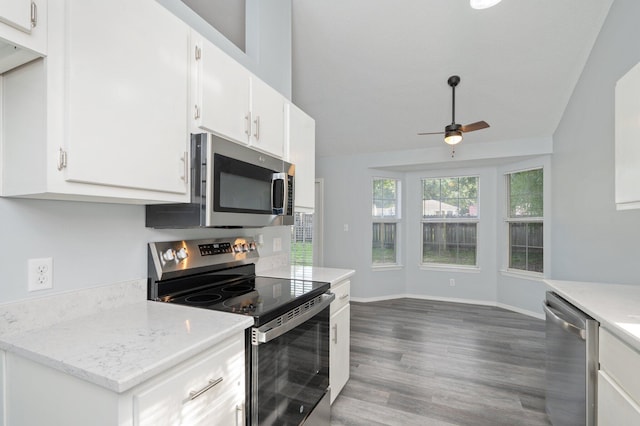504 Shortwell Ave, Crestview, FL 32539 - kitchen featuring appliances with stainless steel finishes, a ceiling fan, wood finished floors, white cabinetry, and lofted ceiling