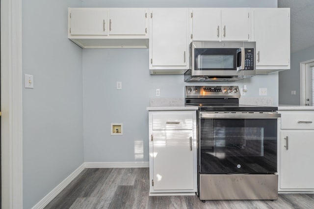 504 Shortwell Ave, Crestview, FL 32539 - kitchen featuring appliances with stainless steel finishes, wood finished floors, light countertops, and white cabinetry