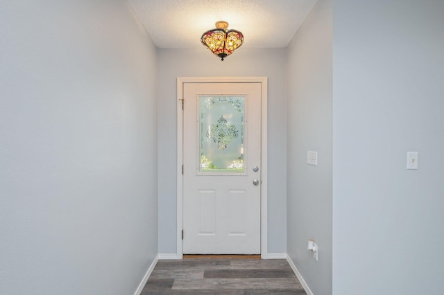504 Shortwell Ave, Crestview, FL 32539 - doorway to outside featuring dark wood finished floors and a textured ceiling