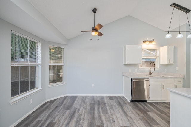 504 Shortwell Ave, Crestview, FL 32539 - kitchen with stainless steel dishwasher, lofted ceiling, light countertops, a ceiling fan, and dark wood-style flooring