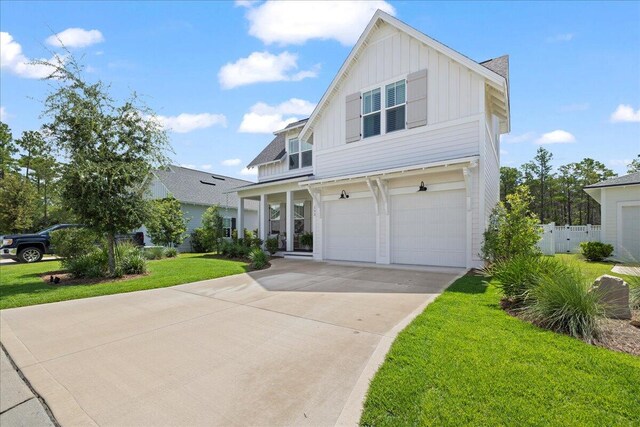 133 E Firethorn Cir, Inlet Beach, FL 32461 - view of front facade with board and batten siding, concrete driveway, and a garage