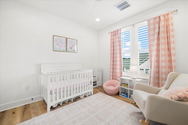 133 E Firethorn Cir, Inlet Beach, FL 32461 - bedroom with wood finished floors, a nursery area, and recessed lighting
