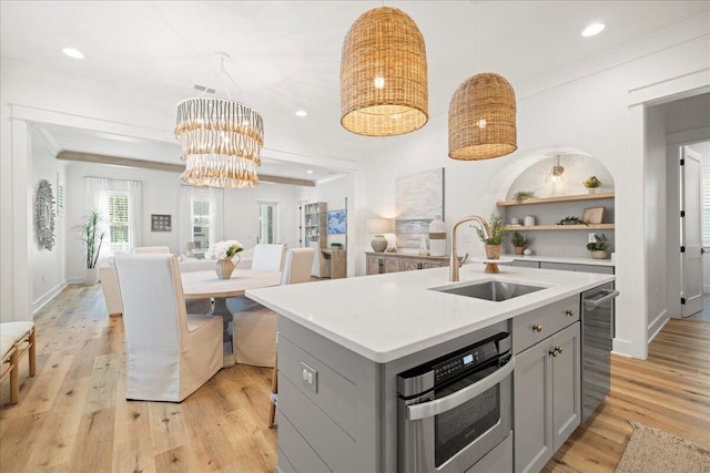 133 E Firethorn Cir, Inlet Beach, FL 32461 - kitchen featuring gray cabinets, light countertops, light wood-style floors, hanging light fixtures, and a kitchen island with sink