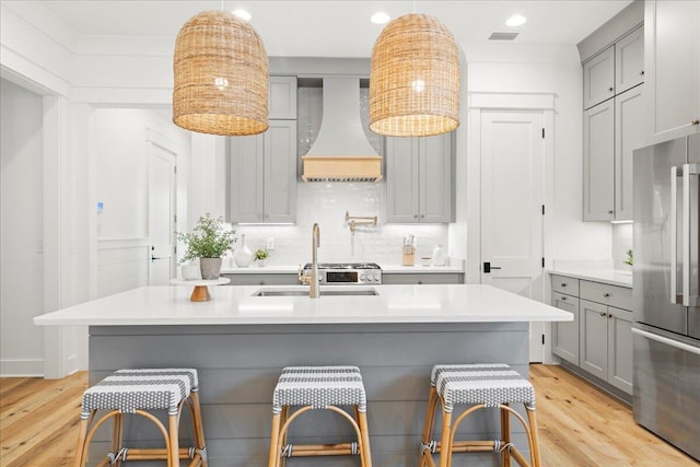 133 E Firethorn Cir, Inlet Beach, FL 32461 - kitchen with gray cabinetry, premium range hood, high quality fridge, light wood-type flooring, and recessed lighting