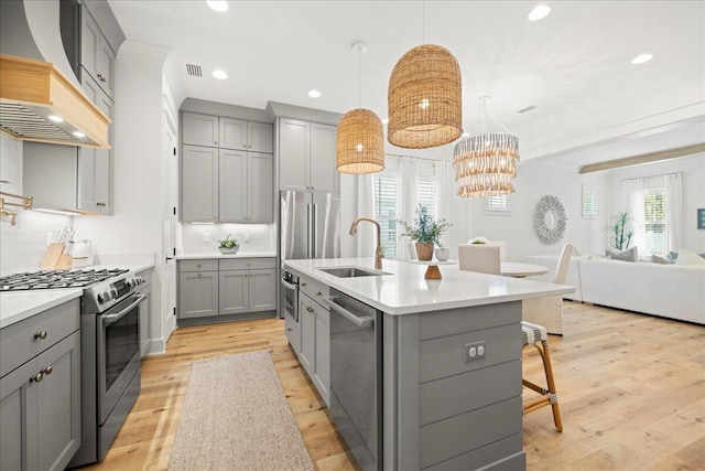 133 E Firethorn Cir, Inlet Beach, FL 32461 - kitchen with gray cabinets, stainless steel appliances, custom exhaust hood, a breakfast bar, and tasteful backsplash