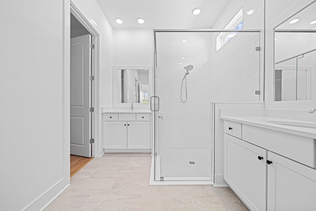 128 Ravine Rd, Watersound, FL 32461 - full bathroom featuring a stall shower, two vanities, recessed lighting, and plenty of natural light