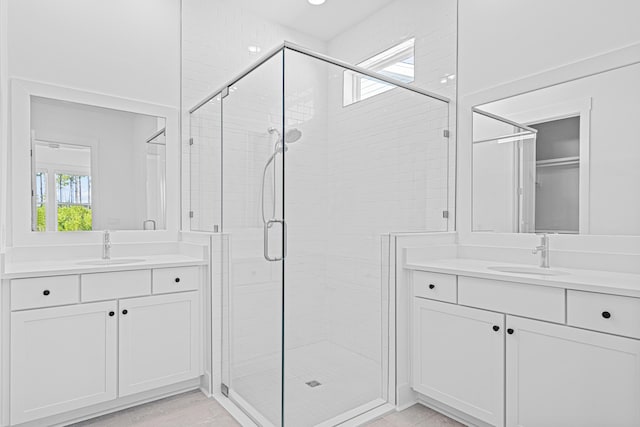 128 Ravine Rd, Watersound, FL 32461 - full bathroom with a stall shower and two vanities