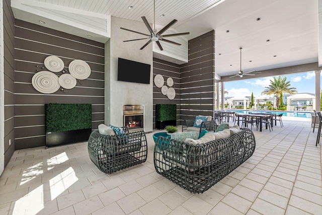 128 Ravine Rd, Watersound, FL 32461 - tiled living area featuring ceiling fan, a lit fireplace, and high vaulted ceiling