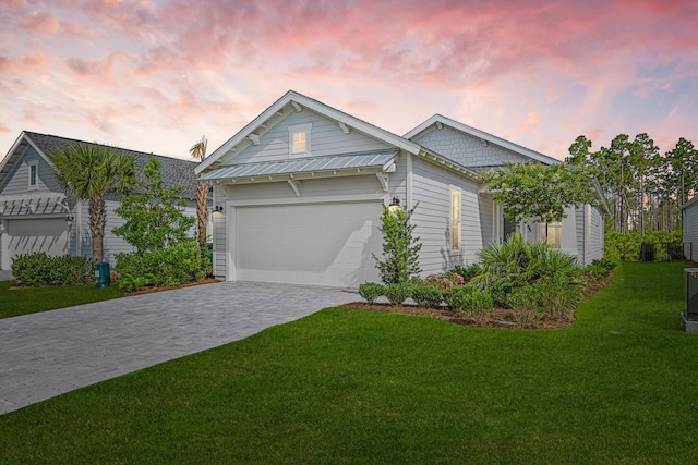 128 Ravine Rd, Watersound, FL 32461 - view of front of property with decorative driveway, a lawn, and an attached garage