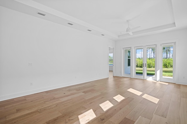 128 Ravine Rd, Watersound, FL 32461 - unfurnished room with plenty of natural light, a tray ceiling, light wood finished floors, and a ceiling fan