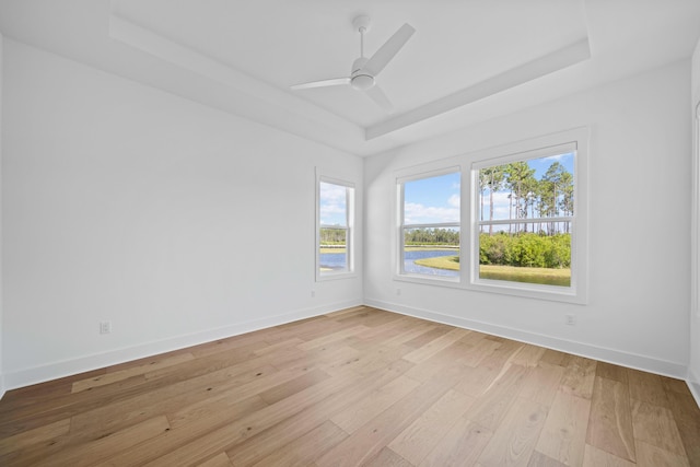 128 Ravine Rd, Watersound, FL 32461 - spare room with a tray ceiling, light wood-style flooring, and ceiling fan