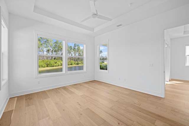 128 Ravine Rd, Watersound, FL 32461 - empty room featuring a tray ceiling, light wood-type flooring, and a ceiling fan
