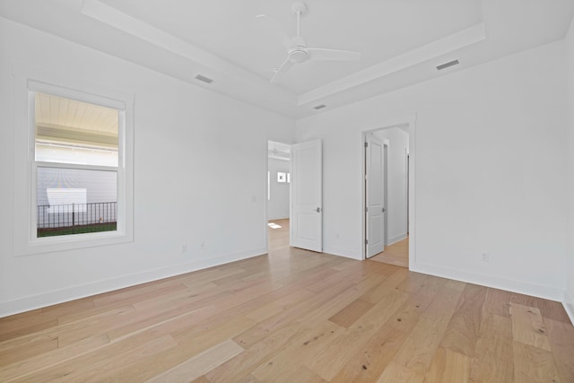 128 Ravine Rd, Watersound, FL 32461 - spare room featuring a tray ceiling, light wood-style flooring, and ceiling fan