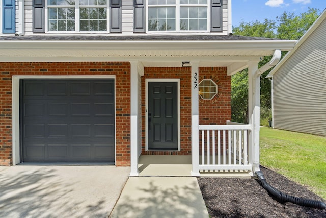 222 Swaying Pine Ct, Crestview, FL 32539 - doorway to property with brick siding, a garage, a porch, and concrete driveway