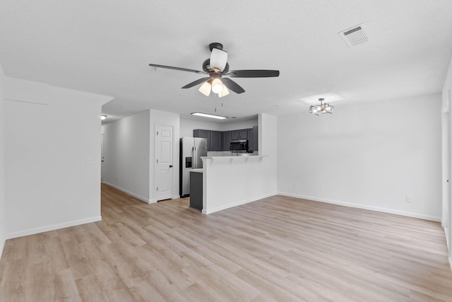 222 Swaying Pine Ct, Crestview, FL 32539 - unfurnished living room featuring ceiling fan, light wood-type flooring, and a chandelier