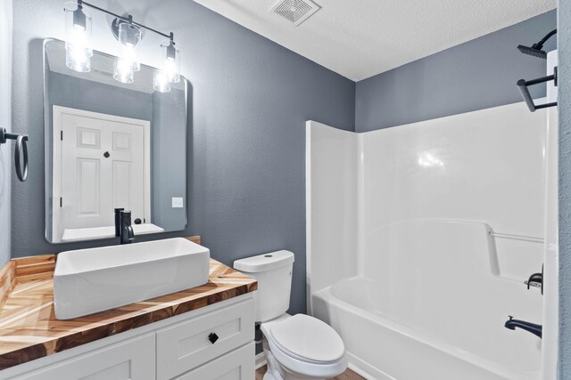 222 Swaying Pine Ct, Crestview, FL 32539 - full bathroom featuring vanity, bathtub / shower combination, a textured wall, and a textured ceiling