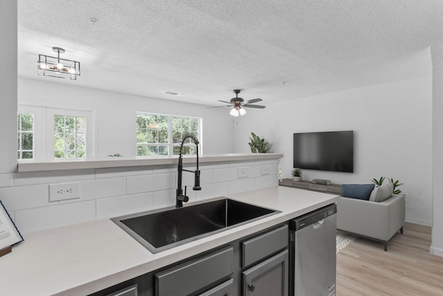 222 Swaying Pine Ct, Crestview, FL 32539 - kitchen with dishwasher, light countertops, gray cabinetry, light wood finished floors, and a textured ceiling