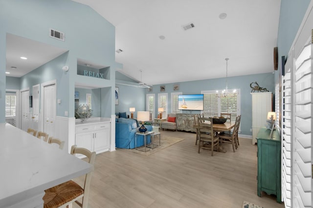 4460 Ocean View Dr, Destin, FL 32541 - dining area featuring healthy amount of natural light, a chandelier, light wood-type flooring, and high vaulted ceiling