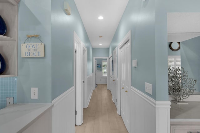 4460 Ocean View Dr, Destin, FL 32541 - hall featuring a wainscoted wall, light wood-style flooring, a decorative wall, and recessed lighting