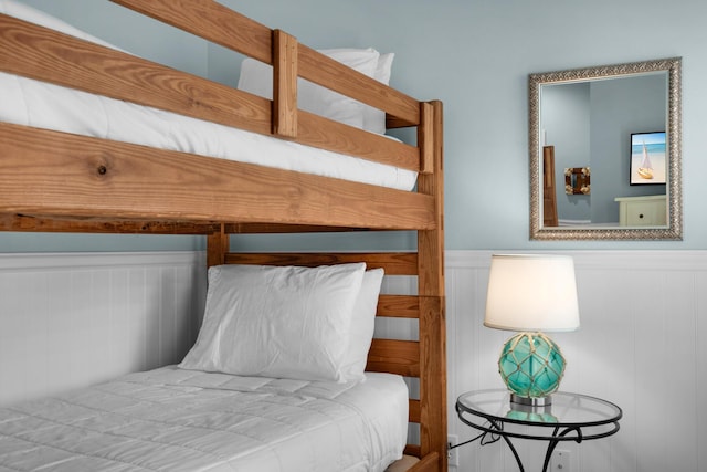 4460 Ocean View Dr, Destin, FL 32541 - bedroom featuring wainscoting and a decorative wall