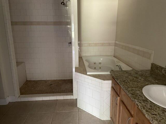 159 Michigan Ln, Defuniak Springs, FL 32433 - full bath featuring a whirlpool tub, a tile shower, tile patterned floors, and vanity