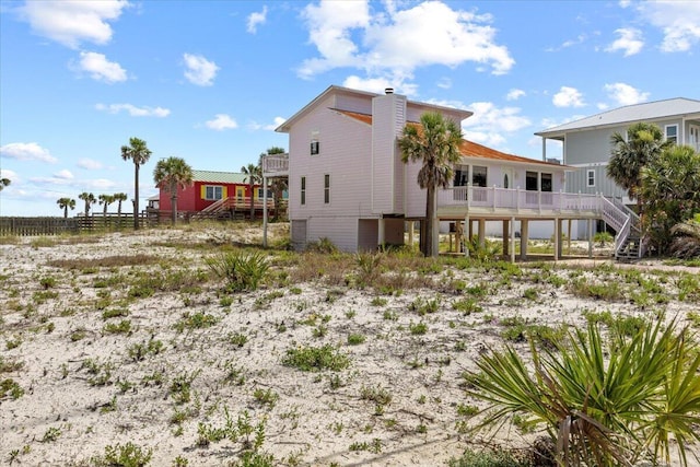 8147 White Sands Blvd, Navarre, FL 32566 - back of house featuring stairway and a chimney
