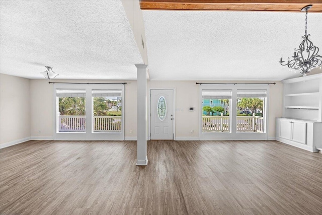 8147 White Sands Blvd, Navarre, FL 32566 - foyer entrance featuring a chandelier, a textured ceiling, and wood finished floors