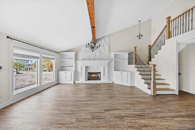 8147 White Sands Blvd, Navarre, FL 32566 - unfurnished living room featuring a chandelier, wood finished floors, high vaulted ceiling, stairway, and beamed ceiling