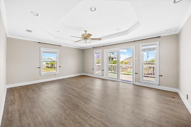 8147 White Sands Blvd, Navarre, FL 32566 - spare room with wood finished floors, crown molding, a ceiling fan, recessed lighting, and a raised ceiling