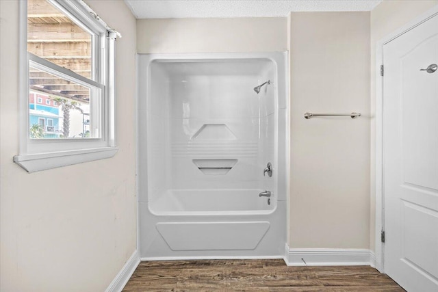 8147 White Sands Blvd, Navarre, FL 32566 - bathroom featuring  shower combination and wood finished floors