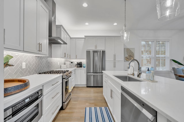 22 Cypress Rdg, Santa Rosa Beach, FL 32459 - kitchen with stainless steel appliances, wall chimney exhaust hood, light countertops, pendant lighting, and recessed lighting