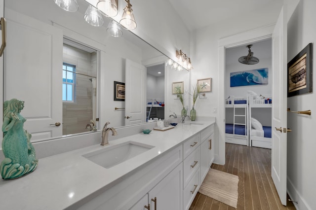 22 Cypress Rdg, Santa Rosa Beach, FL 32459 - bathroom with double vanity, hardwood / wood-style floors, and a tile shower