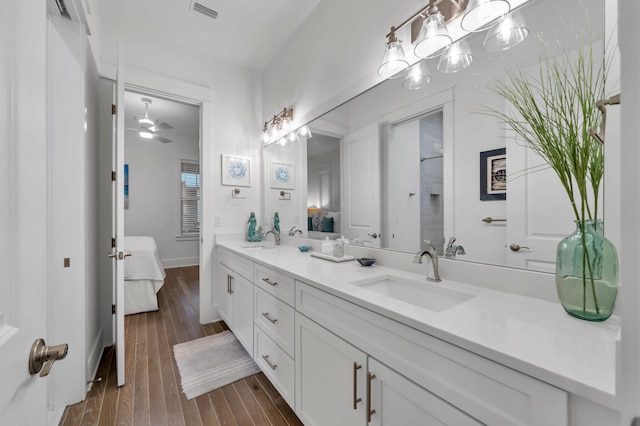 22 Cypress Rdg, Santa Rosa Beach, FL 32459 - ensuite bathroom with double vanity, wood finished floors, and a ceiling fan