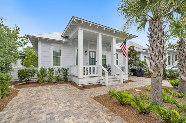 22 Cypress Rdg, Santa Rosa Beach, FL 32459 - shotgun-style home with a porch and a metal roof