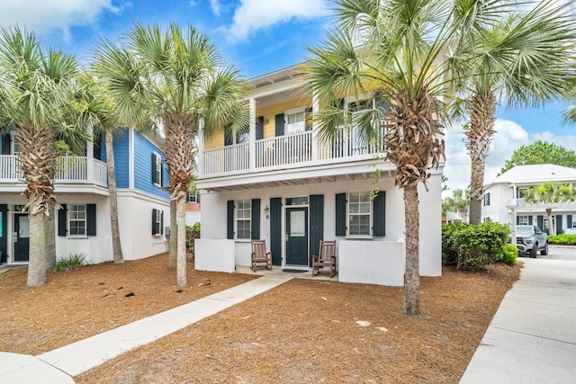 198 Somerset Bridge Rd Unit 143, Santa Rosa Beach, FL 32459 - view of front facade with a balcony, stucco siding, and a porch