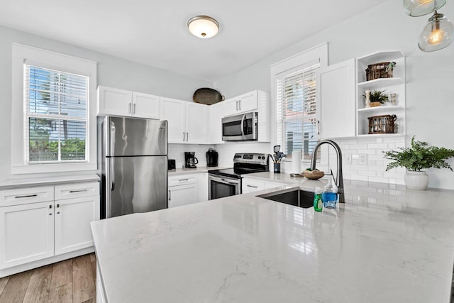 198 Somerset Bridge Rd Unit 143, Santa Rosa Beach, FL 32459 - kitchen featuring stainless steel appliances, plenty of natural light, and light stone countertops