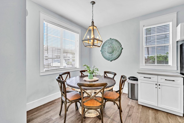 198 Somerset Bridge Rd Unit 143, Santa Rosa Beach, FL 32459 - dining area with a chandelier, healthy amount of natural light, and light wood finished floors