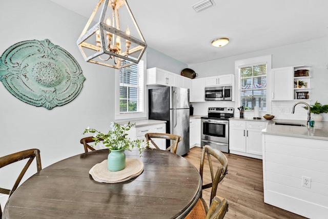 198 Somerset Bridge Rd Unit 143, Santa Rosa Beach, FL 32459 - dining area featuring a chandelier and light wood-style floors