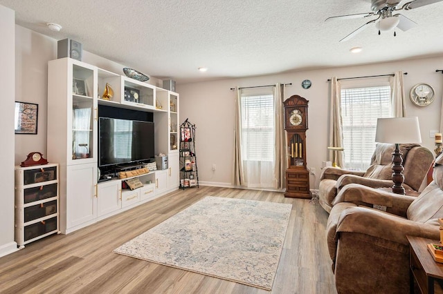 4649 Naval Ct, Crestview, FL 32539 - living area featuring ceiling fan, a textured ceiling, plenty of natural light, and light wood-type flooring