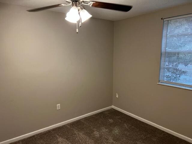 947 Don Dr, Fort Walton Beach, FL 32547 - spare room featuring a ceiling fan, dark carpet, and healthy amount of natural light