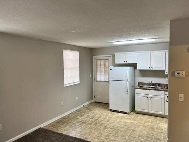947 Don Dr, Fort Walton Beach, FL 32547 - kitchen with freestanding refrigerator and white cabinets
