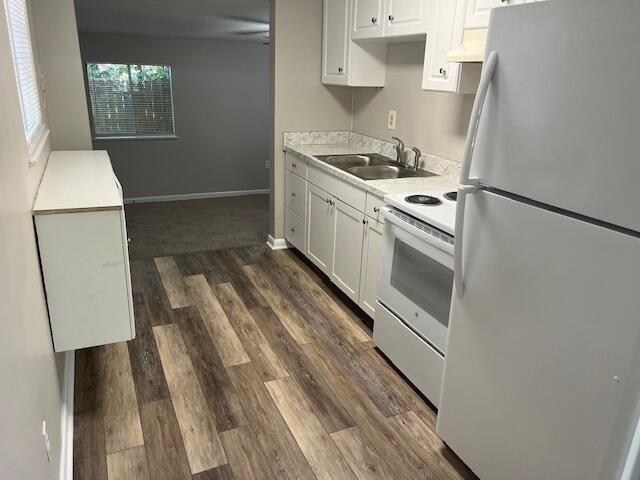 947 Don Dr, Fort Walton Beach, FL 32547 - kitchen with white appliances, dark wood-type flooring, light countertops, and white cabinets