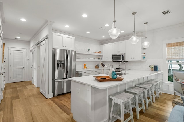 499 Patina Blvd, Inlet Beach, FL 32461 - kitchen with open shelves, stainless steel appliances, ornamental molding, a peninsula, and a kitchen bar