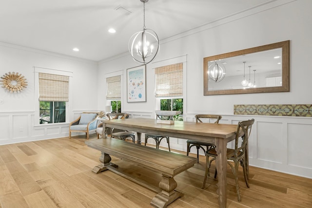 499 Patina Blvd, Inlet Beach, FL 32461 - dining space with a decorative wall, a chandelier, crown molding, wood finished floors, and wainscoting