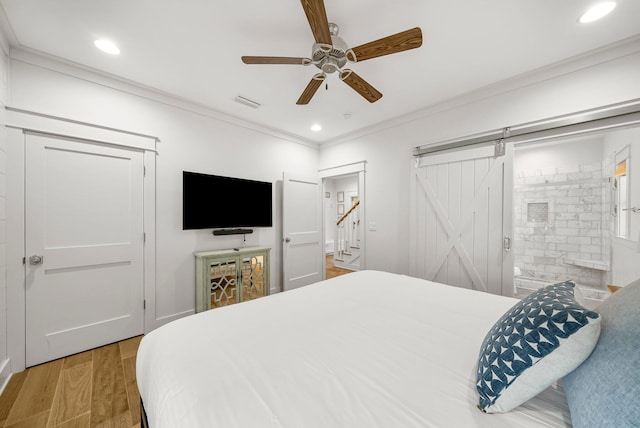 499 Patina Blvd, Inlet Beach, FL 32461 - bedroom with a barn door, ornamental molding, light wood-style flooring, recessed lighting, and ceiling fan
