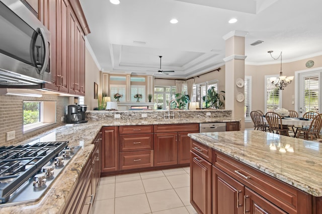 6341 Augusta Cv, Destin, FL 32541 - kitchen featuring stainless steel appliances, light tile patterned flooring, decorative backsplash, a ceiling fan, and a peninsula