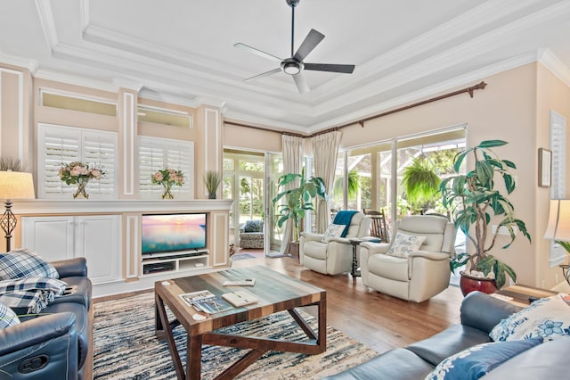 6341 Augusta Cv, Destin, FL 32541 - living room with wood finished floors, ceiling fan, crown molding, and a raised ceiling