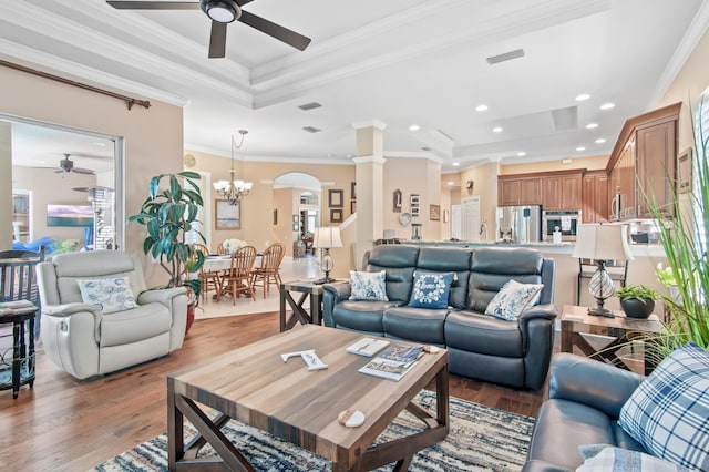 6341 Augusta Cv, Destin, FL 32541 - living area featuring a raised ceiling, a ceiling fan, light wood-style flooring, ornate columns, and crown molding