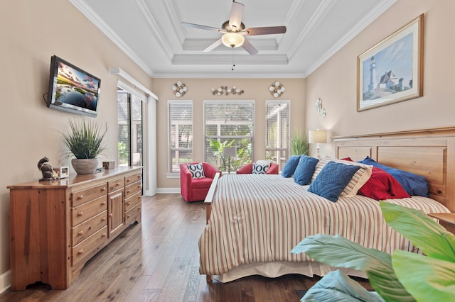 6341 Augusta Cv, Destin, FL 32541 - bedroom featuring a tray ceiling, light wood finished floors, ornamental molding, and ceiling fan